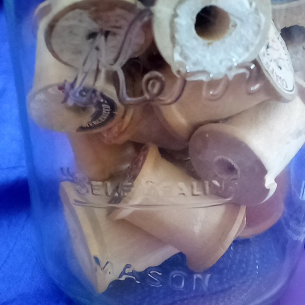 Vintage kerr Mason jar with 25 vintage wooden thread spools